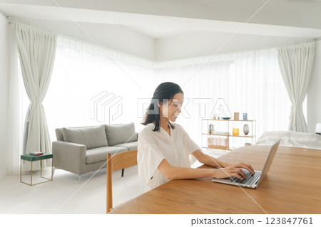 A woman using a computer A woman using a computer 123847761