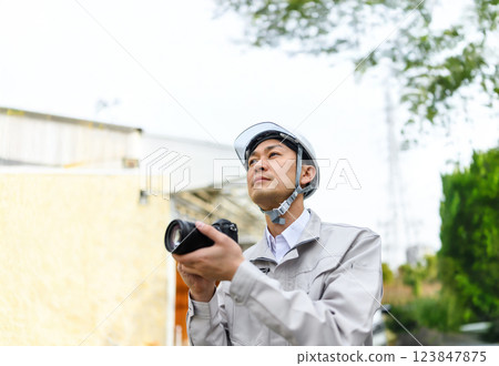 Male worker taking a record Male worker taking a record 123847875