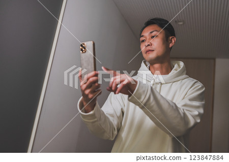 Male portrait operating a smartphone 123847884