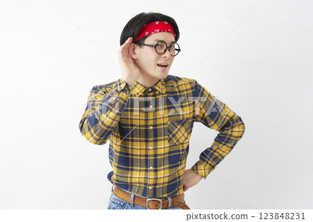 Akihabara-style man listening with hand on ear, white background 123848231
