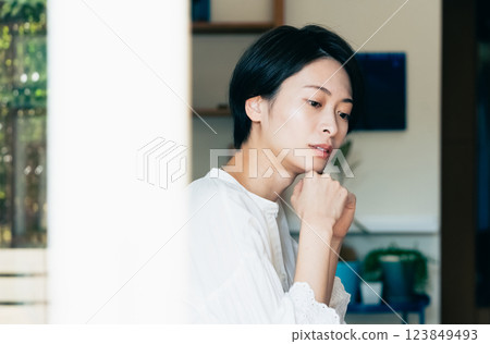 Woman thinking in the living room Woman thinking in the living room 123849493