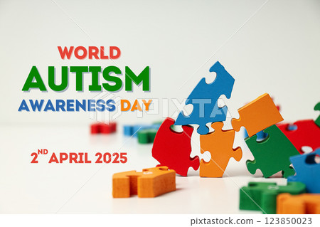 Autism Day, colorful wooden puzzles and text on white background 123850023
