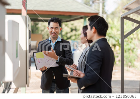 Sustainable energy solutions. Professionals engaged in a positive discussion about energy management strategies. Sustainable energy solutions. Professionals engaged in a positive discussion about energy management strategies. 123850365