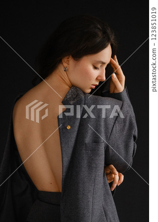Elegant woman in grey suit with bare back 123851019