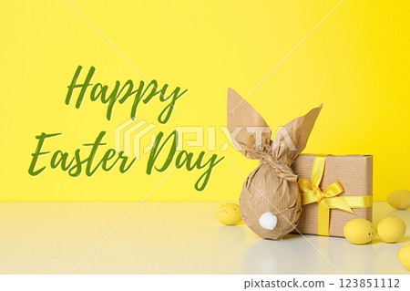 Easter, text: "Happy Easter Day" with gift, on yellow background Easter, text: "Happy Easter Day" with gift, on yellow background 123851112