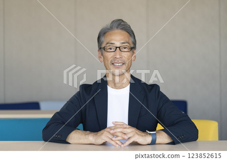 A man in his 60s talking to the camera A man in his 60s talking to the camera 123852615