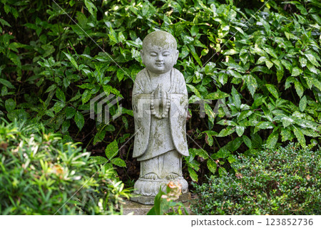 A Serene Statue in a Chinese Garden 123852736
