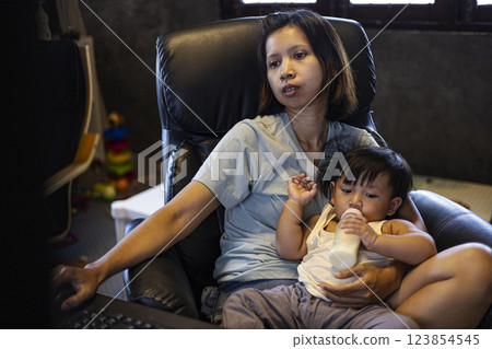 Working Mother With Toddler Who Doesn't Go Anywhere, Background for advertising and wallpaper in work and drink lifestyle scene. Working Mother With Toddler Who Doesn't Go Anywhere, Background for advertising and wallpaper in work and drink lifestyle scene. 123854545