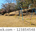 An empty park with benches and swings 123854548