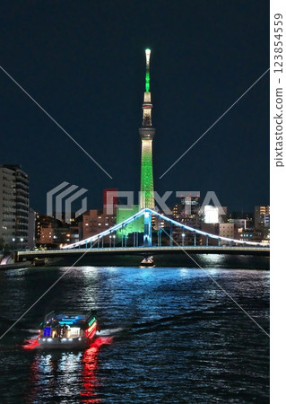 Winter: Night view of the illuminated green Skytree, Kiyosubashi Bridge over the Sumida River, and a houseboat Winter: Night view of the illuminated green Skytree, Kiyosubashi Bridge over the Sumida River, and a houseboat 123854559