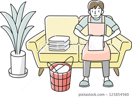 A man wearing an apron folding laundry 123854560