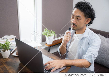 40 歲左右再培訓:男性在家學習以獲得資格證書等。 40 歲左右再培訓:男性在家學習以獲得資格證書等。 123854825
