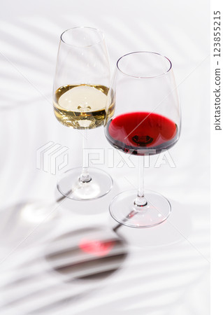 Two wine glasses filled with red and white wine Two wine glasses filled with red and white wine 123855215