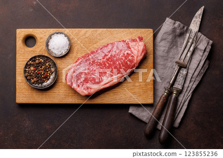 Raw marbled striploin steak, fresh, rich, ready for cooking Raw marbled striploin steak, fresh, rich, ready for cooking 123855236