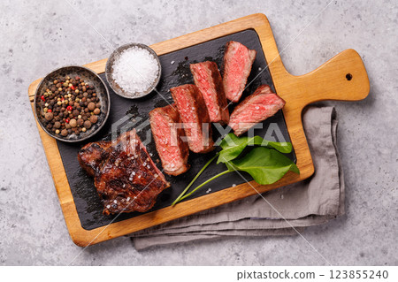 A perfectly cooked sliced striploin steak with a juicy, tender texture A perfectly cooked sliced striploin steak with a juicy, tender texture 123855240