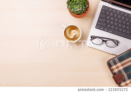 A clean and minimal desk setup featuring a laptop and a coffee cup A clean and minimal desk setup featuring a laptop and a coffee cup 123855272