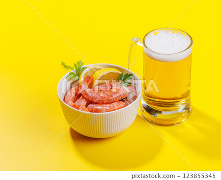 A vibrant photo showcasing a glass of beer and fresh shrimps A vibrant photo showcasing a glass of beer and fresh shrimps 123855345