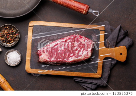 Raw marbled striploin steak, fresh, rich, ready for cooking Raw marbled striploin steak, fresh, rich, ready for cooking 123855375
