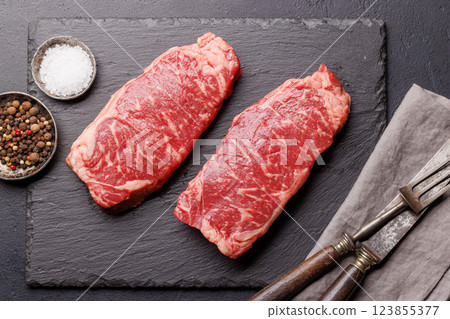Raw marbled striploin steak, fresh, rich, ready for cooking Raw marbled striploin steak, fresh, rich, ready for cooking 123855377