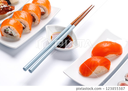 Assorted sushi and maki rolls beautifully arranged on plates Assorted sushi and maki rolls beautifully arranged on plates 123855387