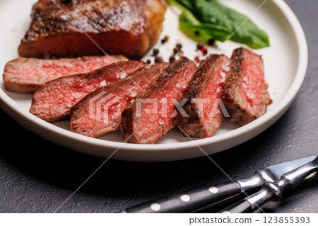 A perfectly cooked sliced striploin steak with a juicy, tender texture 123855393