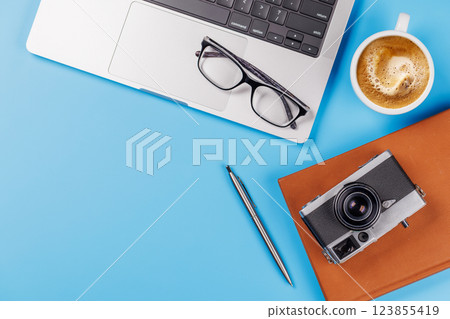 A clean and minimal desk setup featuring a laptop and a coffee cup A clean and minimal desk setup featuring a laptop and a coffee cup 123855419