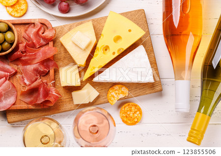 A delectable arrangement of various cheeses, fresh grapes, prosciutto and wine 123855506