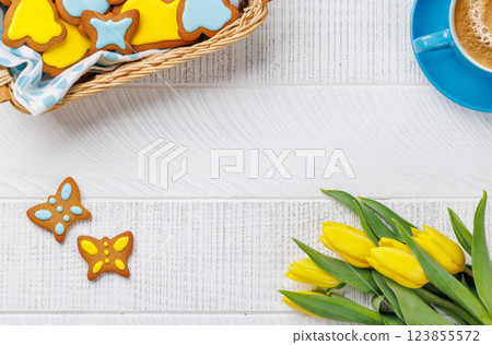 Easter Bunny-Shaped Gingerbread Cookies, Yellow Tulips, and Coffee Cup 123855572