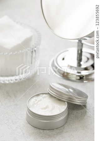 Magnifying glass and moisturizing cream for dry skin care image Magnifying glass and moisturizing cream for dry skin care image 123855692