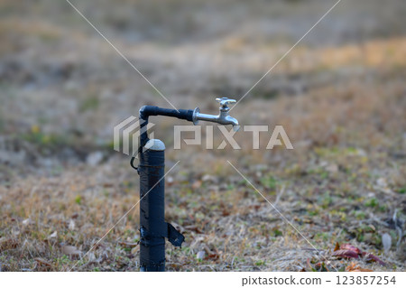 Watering faucet in the flower garden at Yakushiike Park 123857254