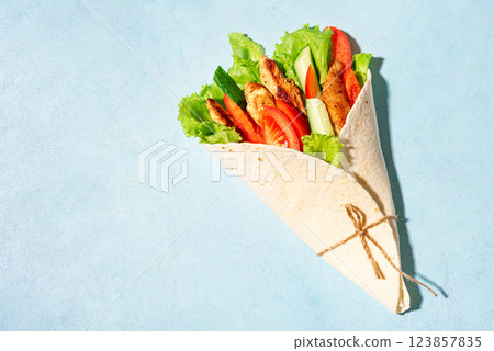 Grilled chicken and vegetables salad tortilla wrap 123857835