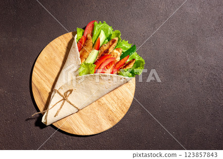 Grilled chicken wrap with fresh vegetables. Greek gyro wrap. 123857843