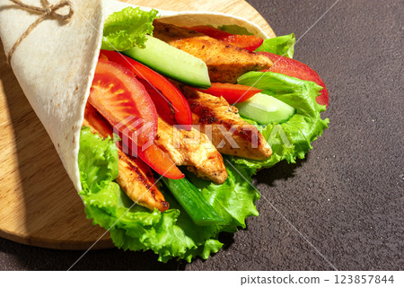 Grilled chicken and vegetables wrap 123857844