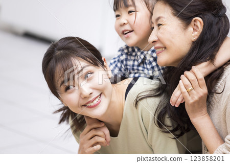 Three generations playing happily Three generations playing happily 123858201