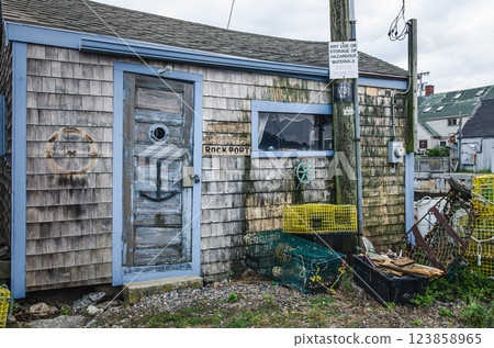 Weathered wooden fishing shack with lobster traps, Massachusetts, United States, North America  123858965
