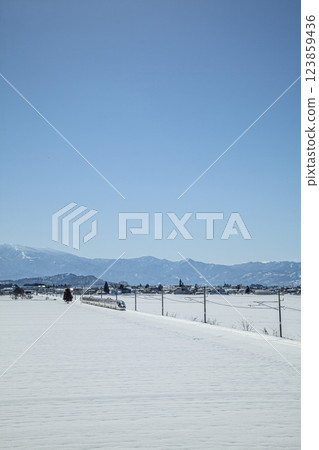 Shinkansen train going through snowy fields Shinkansen train going through snowy fields 123859436