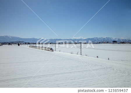 Shinkansen train going through snowy fields Shinkansen train going through snowy fields 123859437