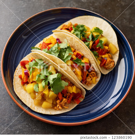 Colorful Tacos on Blue Ceramic Plate 123860190