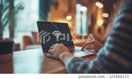 A person using a laptop in a cozy cafe encounters a no WiFi connection error on the screen, disrupting their work. A person using a laptop in a cozy cafe encounters a no WiFi connection error on the screen, disrupting their work. 123860233