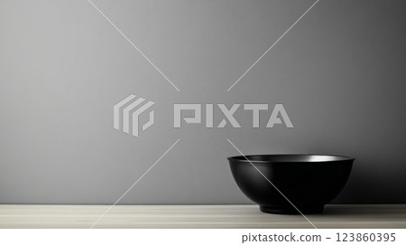 Empty black bowl on plain backdrop Empty black bowl on plain backdrop 123860395