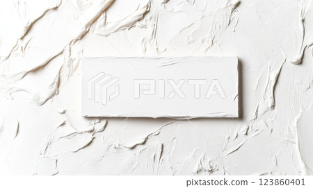 White torn paper rectangle on textured surface 123860401