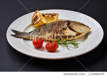 Grilled Fish Garnished with Lemon and Herbs Grilled Fish Garnished with Lemon and Herbs 123860476