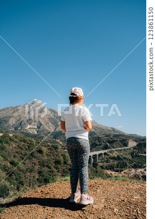 Hispanic child enjoying mountain view on a sunny day, slow living, hiking, off-grid life, free 123861150
