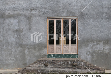 Scenery of a building with a door in the wall Scenery of a building with a door in the wall 123861196