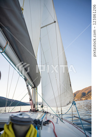 Yacht sailing in Adriatic sea. Close-up view of the deck, mast and sails. Yachting concept Yacht sailing in Adriatic sea. Close-up view of the deck, mast and sails. Yachting concept 123861206