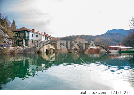 Arched bridge over Crnojevic river in small town near Skadar lake in Montenegro in winter time Arched bridge over Crnojevic river in small town near Skadar lake in Montenegro in winter time 123861234