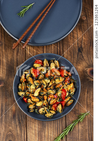 Plate of mussels on a table. 123861264