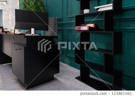 The luxurious office of the director of the company. It has a modern wooden table with a computer and an ergonomic armchair. Shelves for documents with space for copying. High quality photo The luxurious office of the director of the company. It has a modern wooden table with a computer and an ergonomic armchair. Shelves for documents with space for copying. High quality photo 123861561