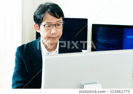 Middle-aged man facing a computer 123861773