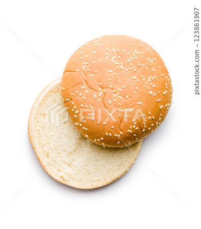 Empty burger bun with sesame seeds isolated on white background. Empty burger bun with sesame seeds isolated on white background. 123861907